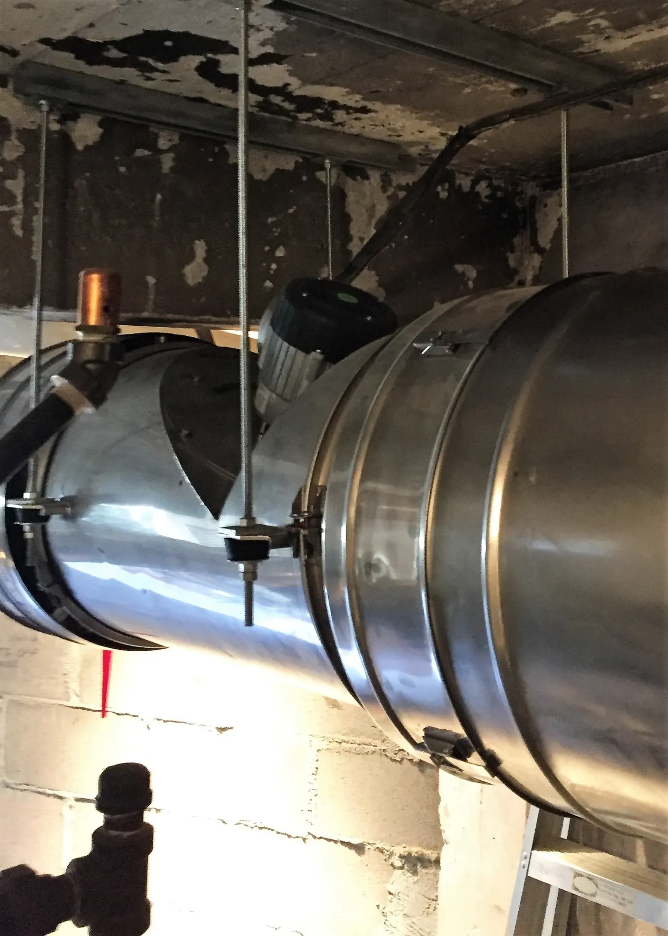 Enervex TDF250 inline fan inducing draft at the appliance outlet.